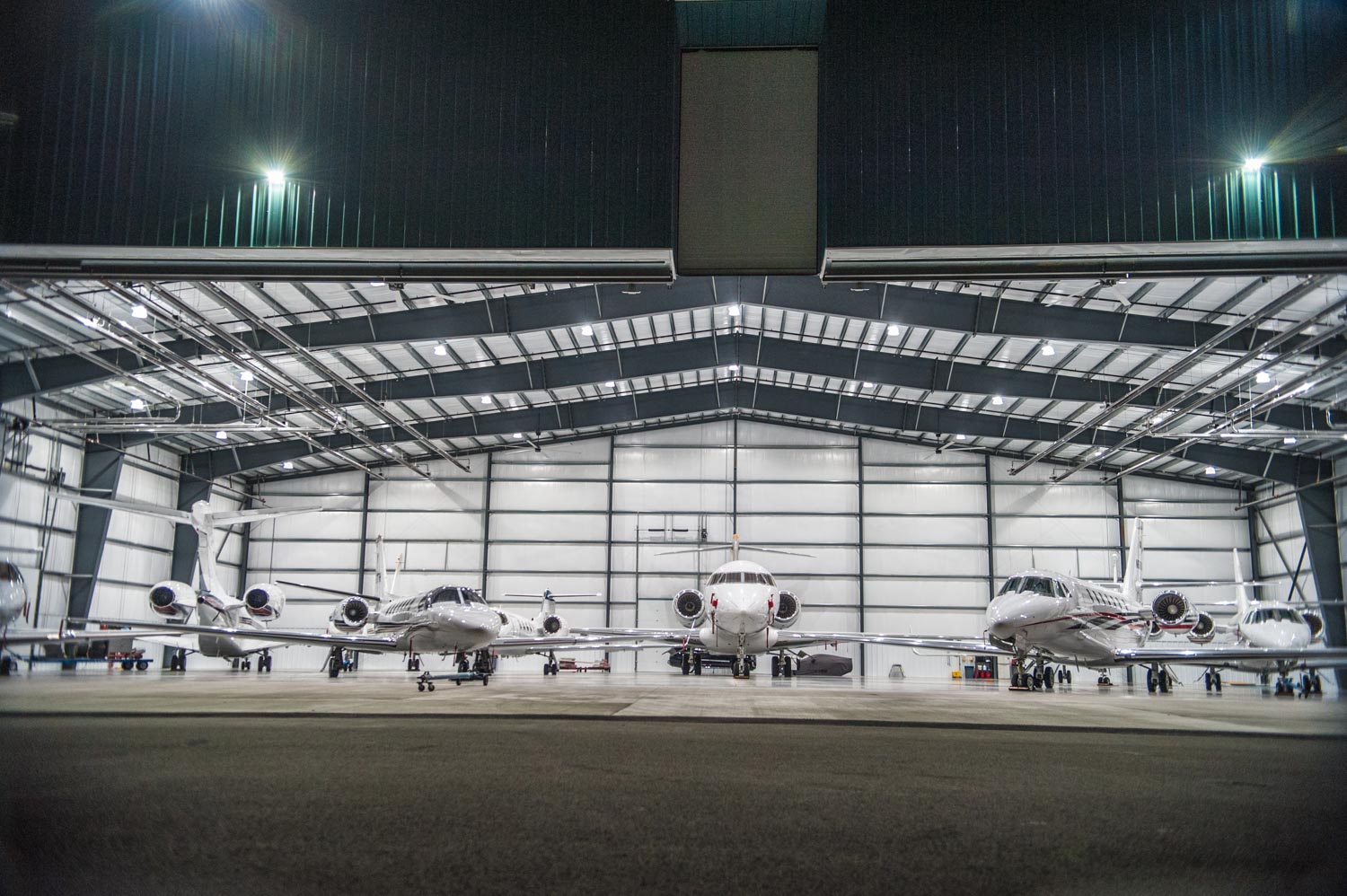 Night time photo of LJ Aviation hanger front wide