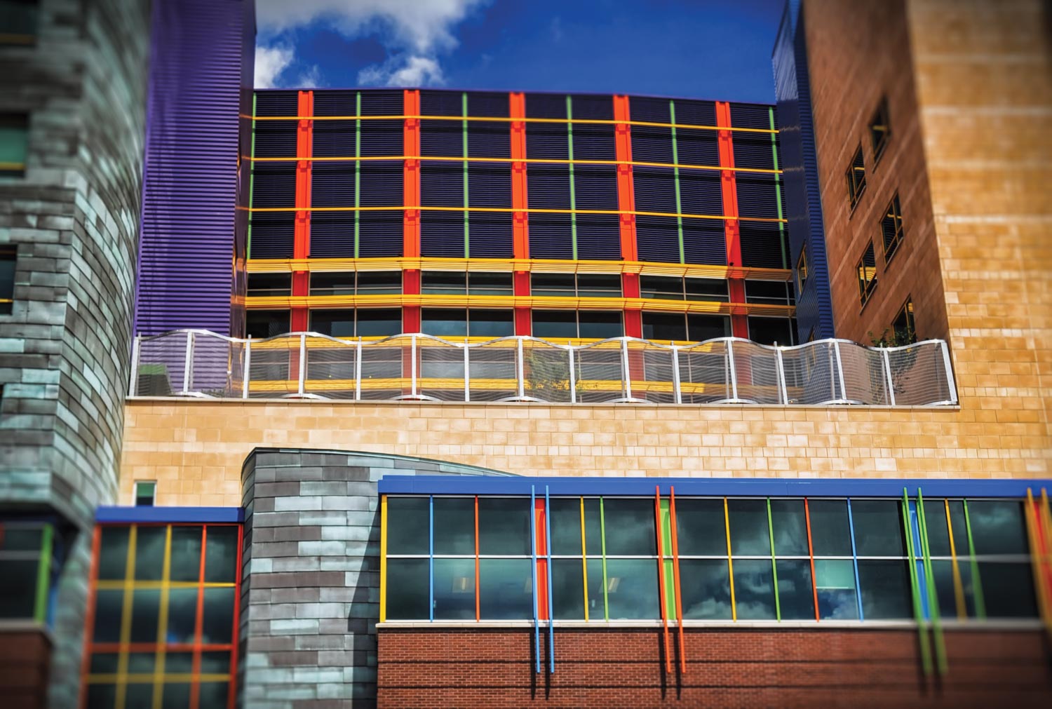 Close up of building Children's Hospital metal patina panels installed plus accent orange,green,purple, louvers photograph